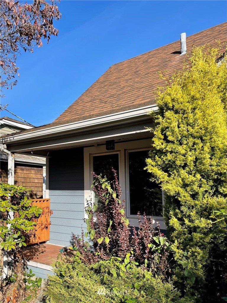 3820 35th Avenue Southwest Seattle, WA 98126 - Photo 1 of 27 a front view of a house with a yard