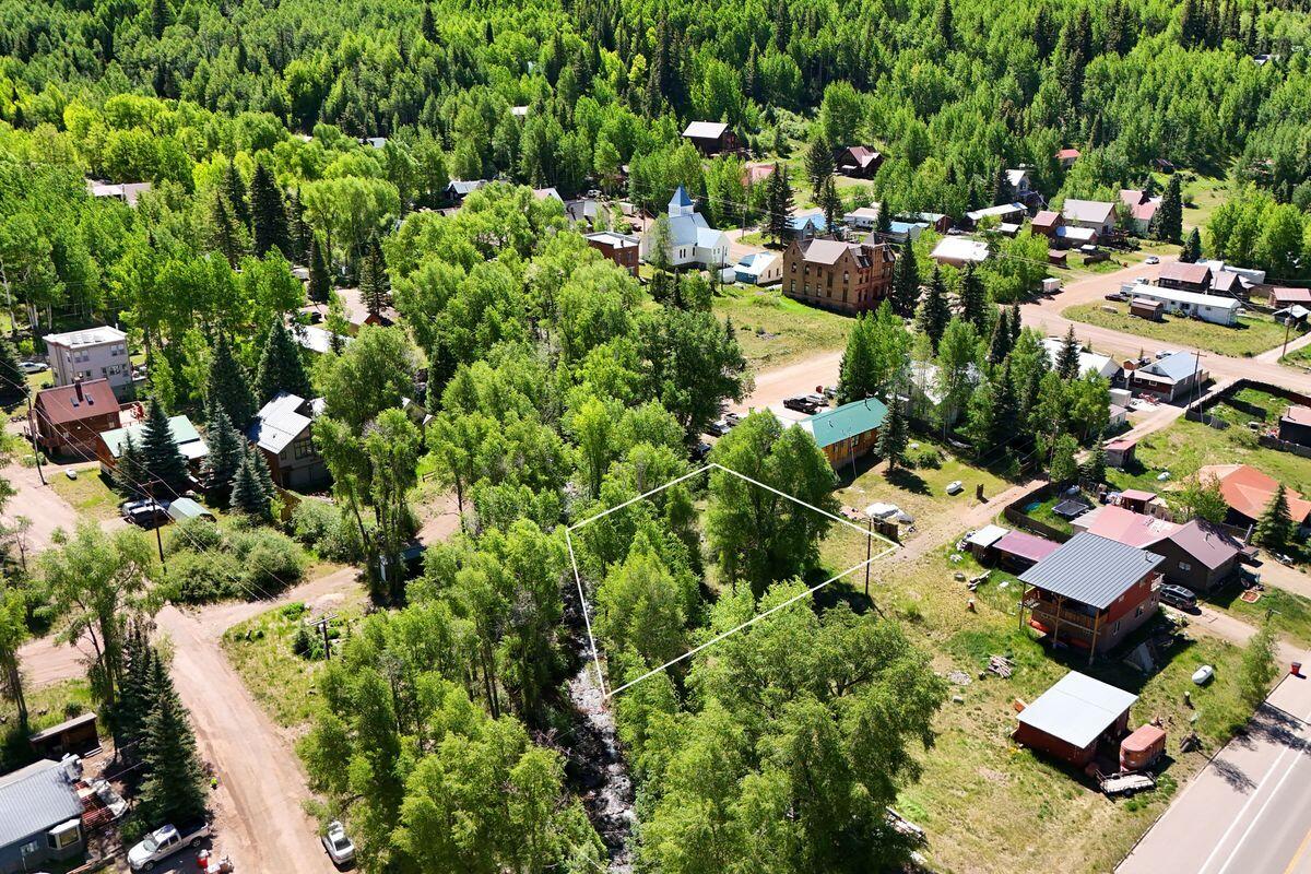27 North Commercial Street Rico, CO 81332 - Photo 5 of 17 an aerial view of residential houses with outdoor space and trees all around