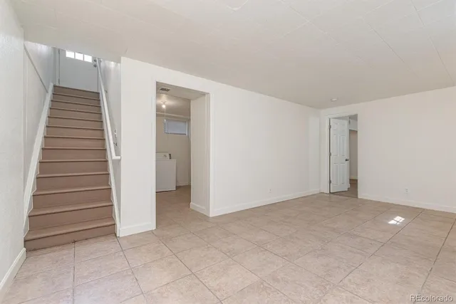 a view of an empty room with stairs and ventilation