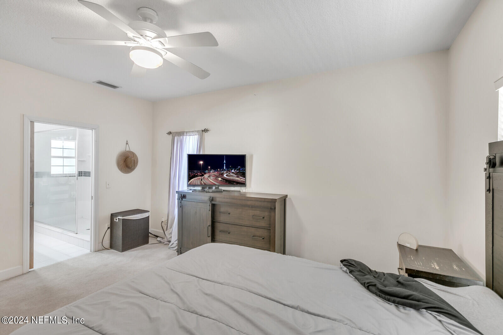 5860 County Road 208 St. Augustine, FL 32092 - Photo 18 of 34 a bedroom with a bed and a flat screen tv