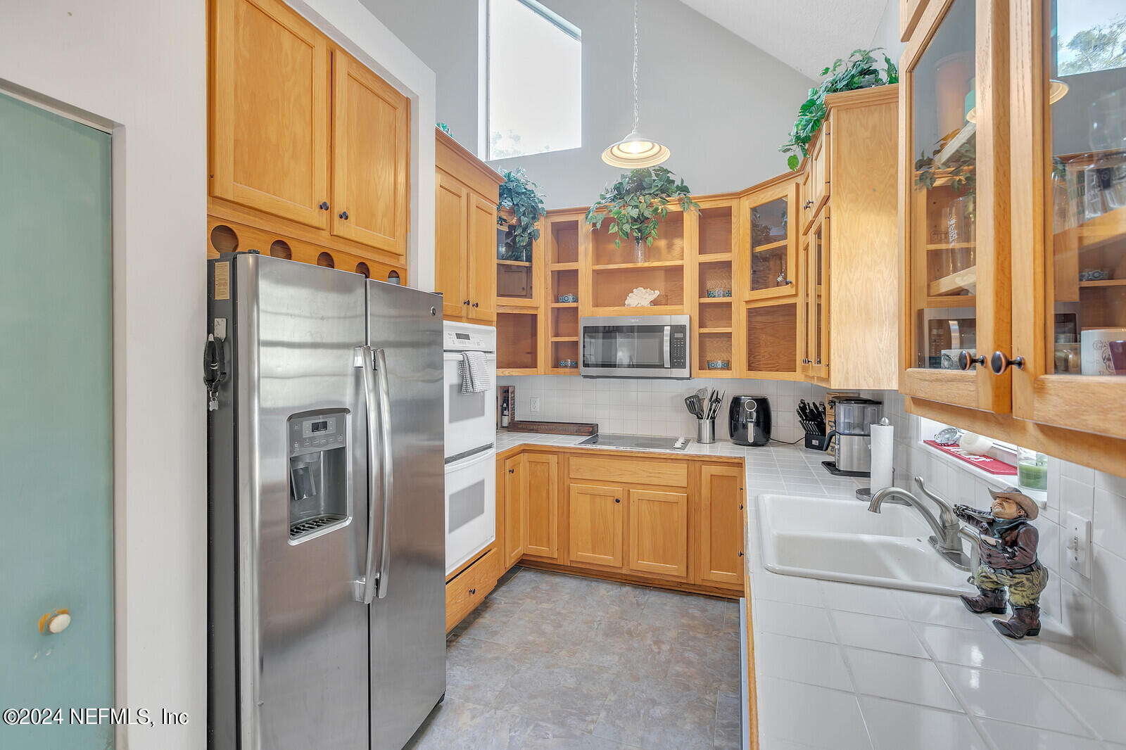 5860 County Road 208 St. Augustine, FL 32092 - Photo 10 of 34 a kitchen with stainless steel appliances granite countertop a refrigerator and a stove top oven
