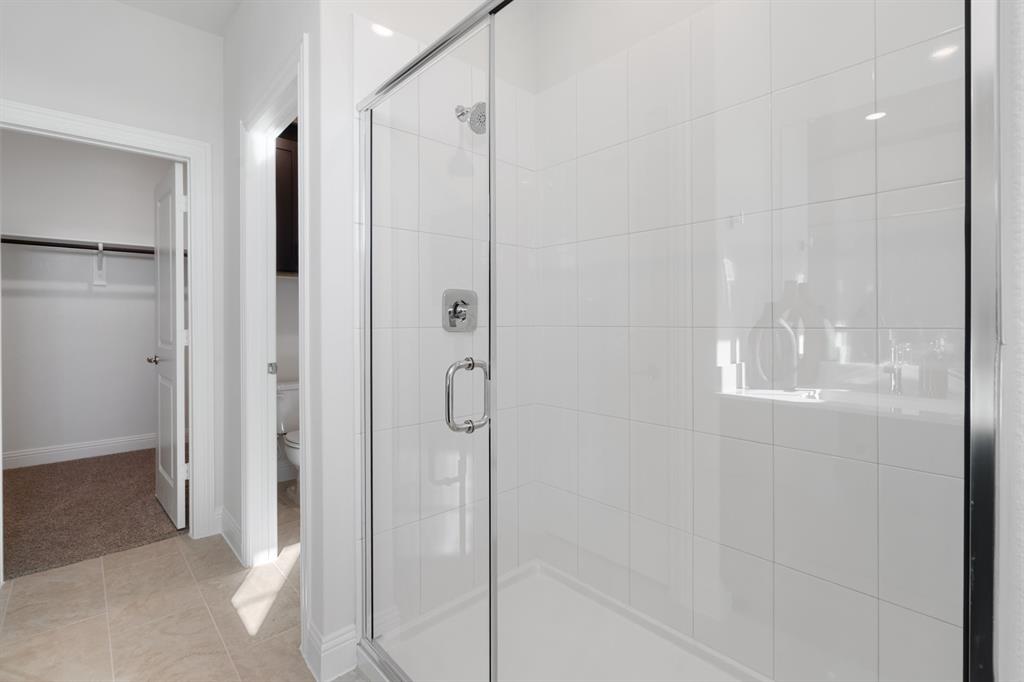 1008 Snapdragon Drive Euless, TX 76039 - Photo 8 of 12 a bathroom with a glass shower door