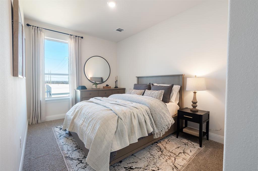 1008 Snapdragon Drive Euless, TX 76039 - Photo 10 of 12 a bedroom with a bed and a mirror