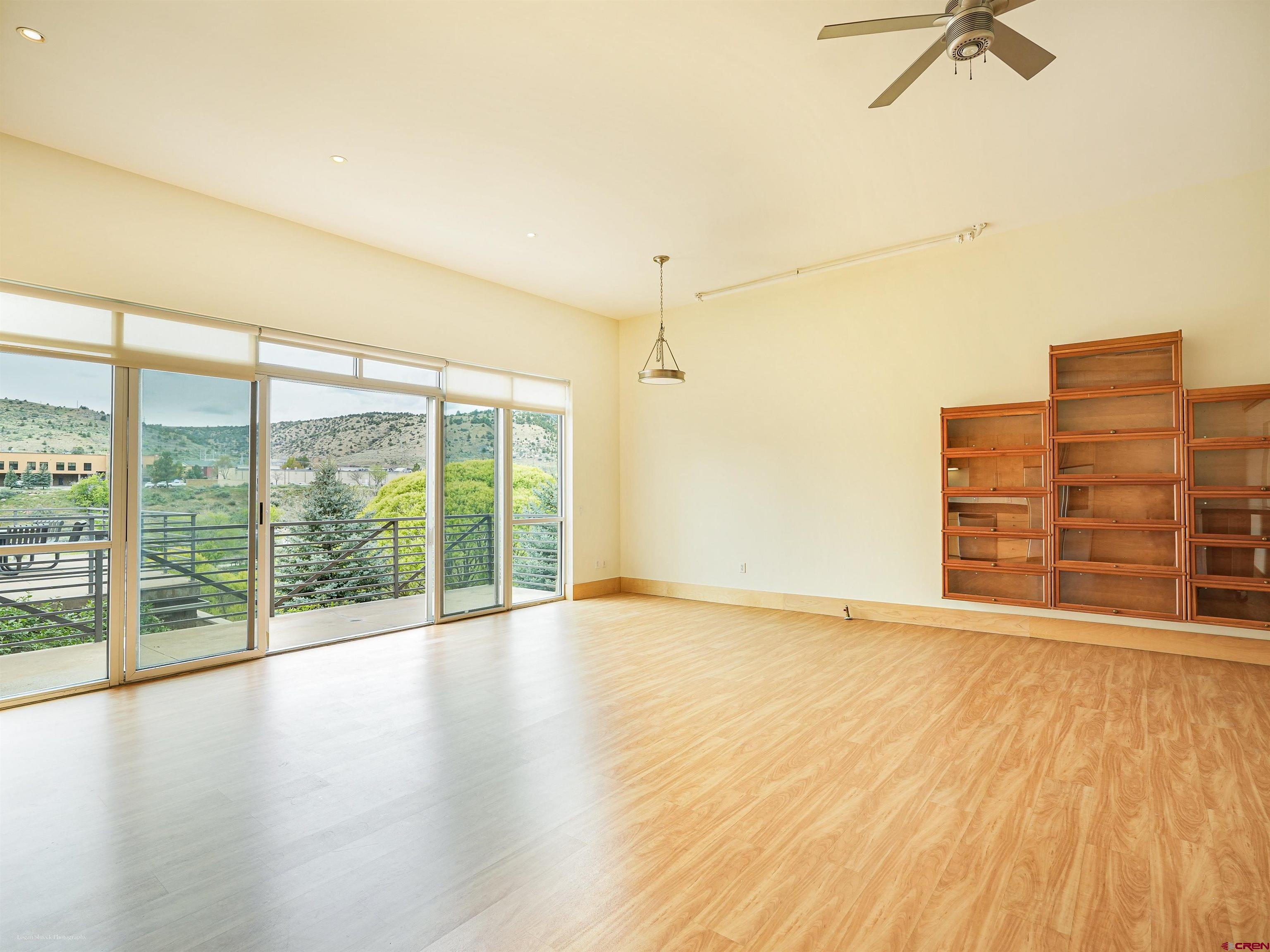 555 Rivergate Lane, Unit B2139 Durango, CO 81301 - Photo 11 of 32 a view of an empty room with wooden floor and a window