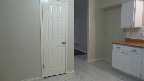 a view of a kitchen with white cabinets