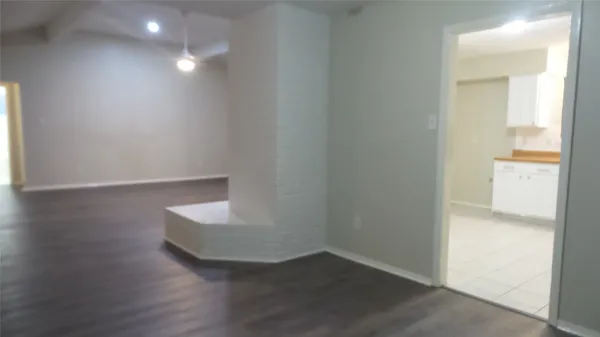 a view of an empty room and wooden floor