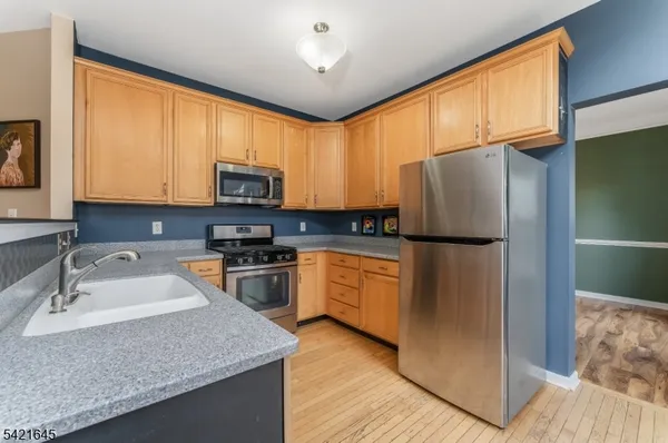 a kitchen with stainless steel appliances granite countertop a stove and a sink