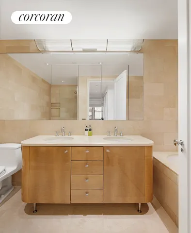 a spacious bedroom with a bed a couch and a window