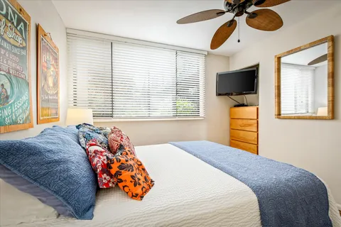 a bedroom with a bed and a chandelier