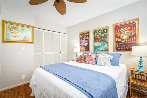 a bedroom with a bed and a painting on the wall