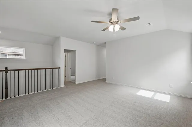 a view of an empty room with a ceiling fan