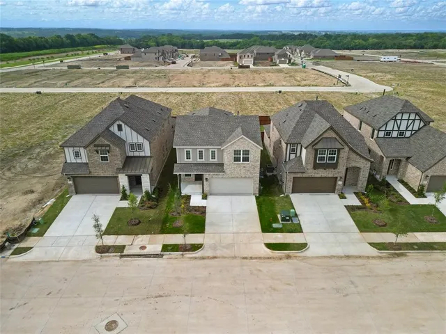 an aerial view of a house with a yard and lake view