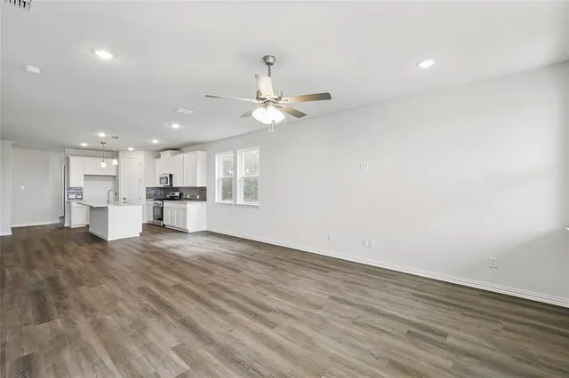 a view of kitchen with granite countertop cabinets and refrigerator