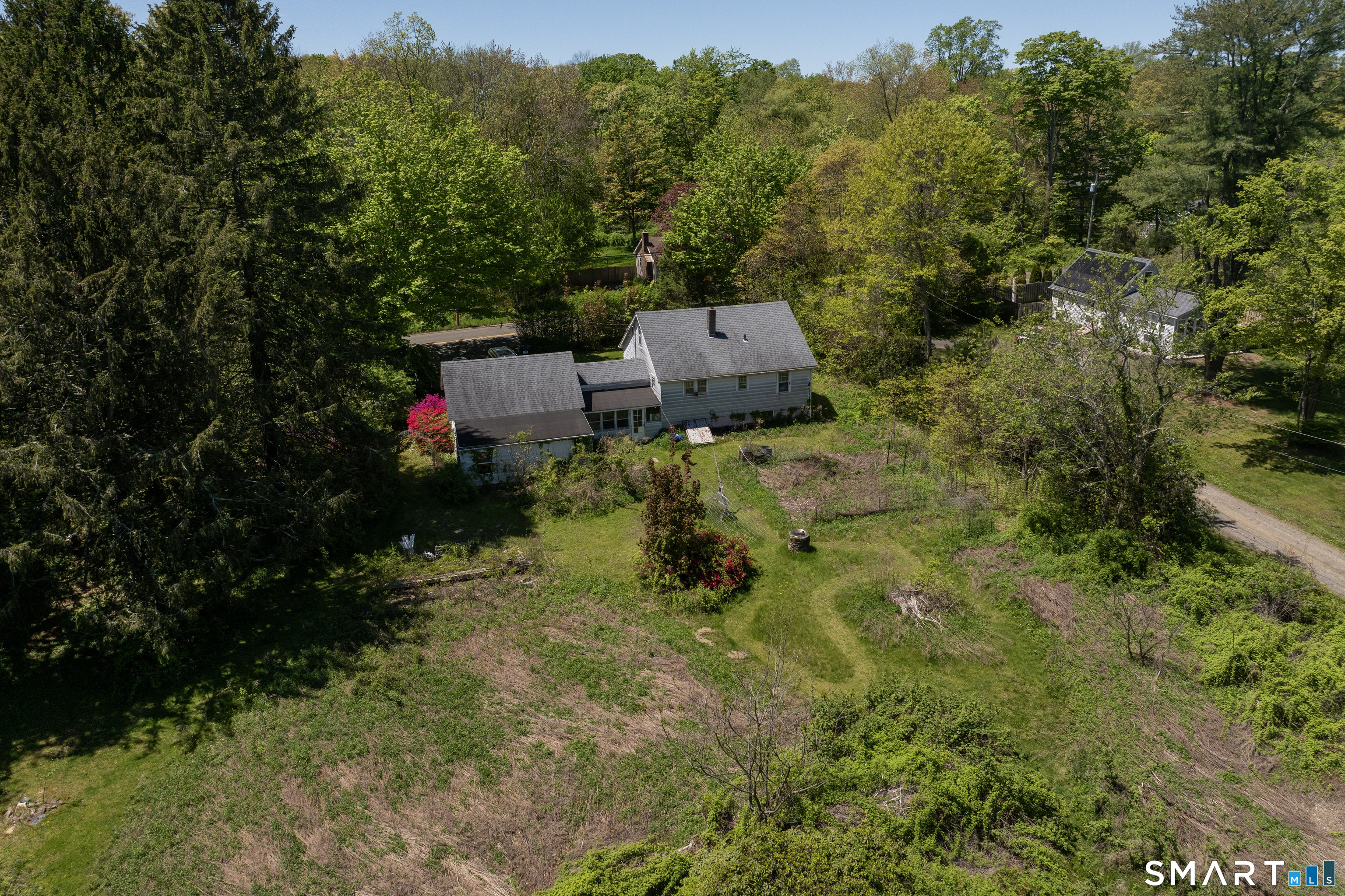 1973 Long Hill Road Guilford, CT 06437 - Photo 5 of 19 a backyard of a house with lots of green space and a fountain