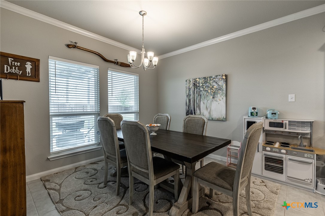 6142 Fairburn Temple, TX 76502 - Photo 11 of 38 a view of a dining room with furniture window and wooden floor