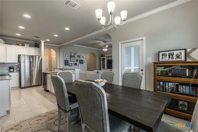 a view of a dining room with furniture and a bookshelf