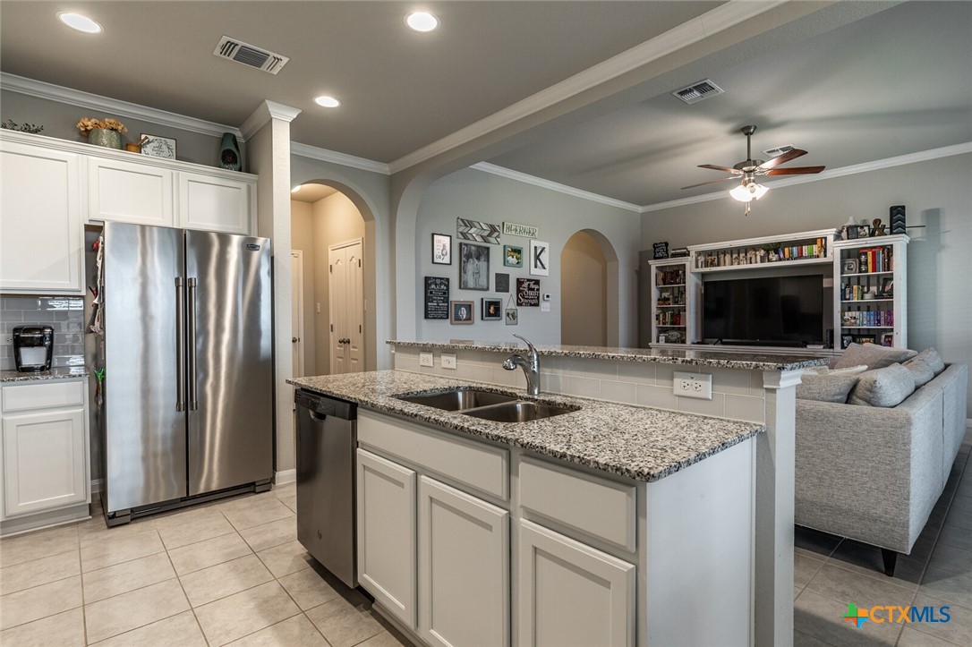 6142 Fairburn Temple, TX 76502 - Photo 13 of 38 a kitchen with stainless steel appliances granite countertop a sink and a refrigerator