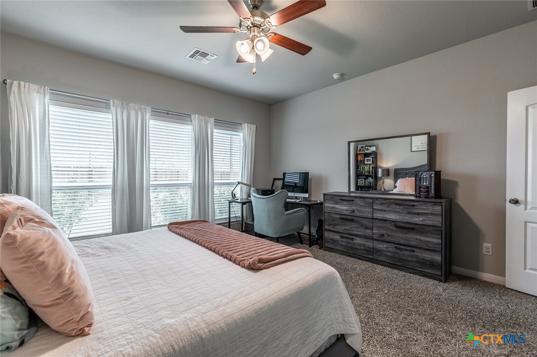 6142 Fairburn Temple, TX 76502 - Photo 19 of 38 a bedroom with a bed and a chandelier