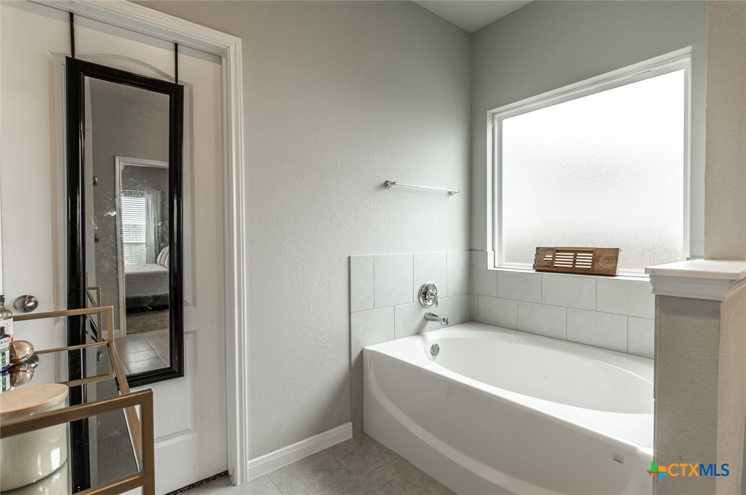 6142 Fairburn Temple, TX 76502 - Photo 23 of 38 a bathroom with a bathtub and a shower