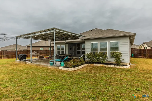 a blue swimming pool is in front of a house