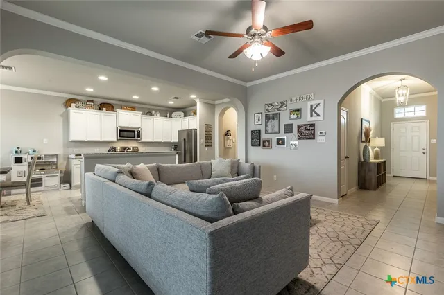 a living room with furniture and kitchen view