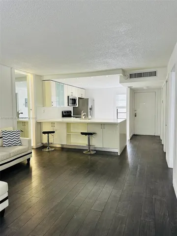 a view of a livingroom with furniture and a flat screen tv