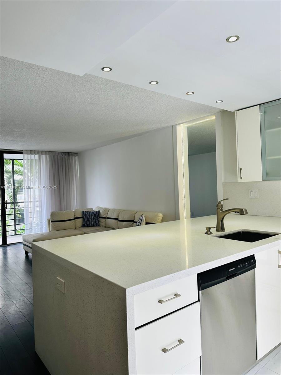 20400 West Country Club Drive, Unit 414 Aventura, FL 33180 - Photo 3 of 5 a kitchen with a sink a stove and cabinets