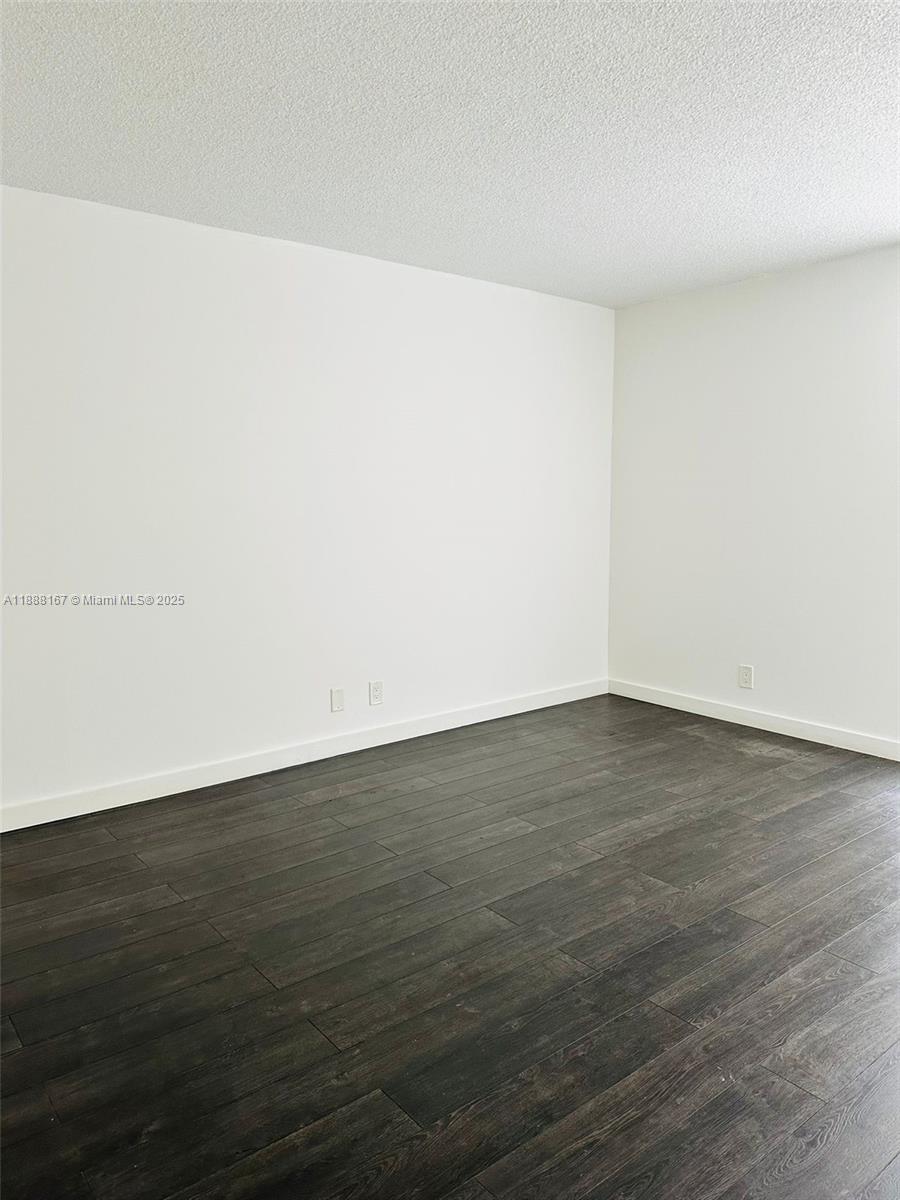 20400 West Country Club Drive, Unit 414 Aventura, FL 33180 - Photo 4 of 5 an empty room with wooden floor