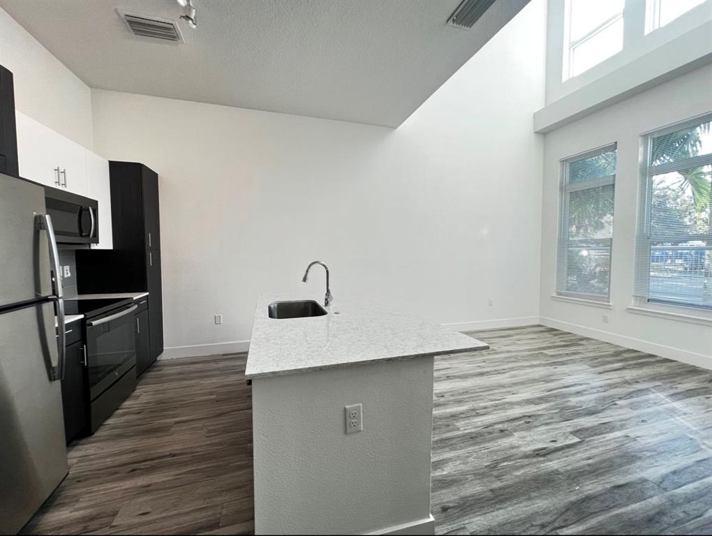 1659 2nd Street Sarasota, FL 34236 - Photo 13 of 24 a kitchen with kitchen island a sink appliances and cabinets