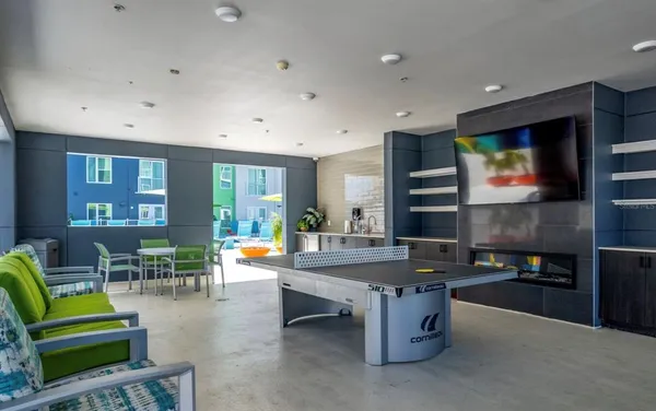 a living room with furniture and a kitchen view