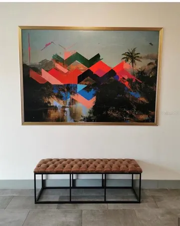 a view of a dining room with furniture a chandelier and wooden floor