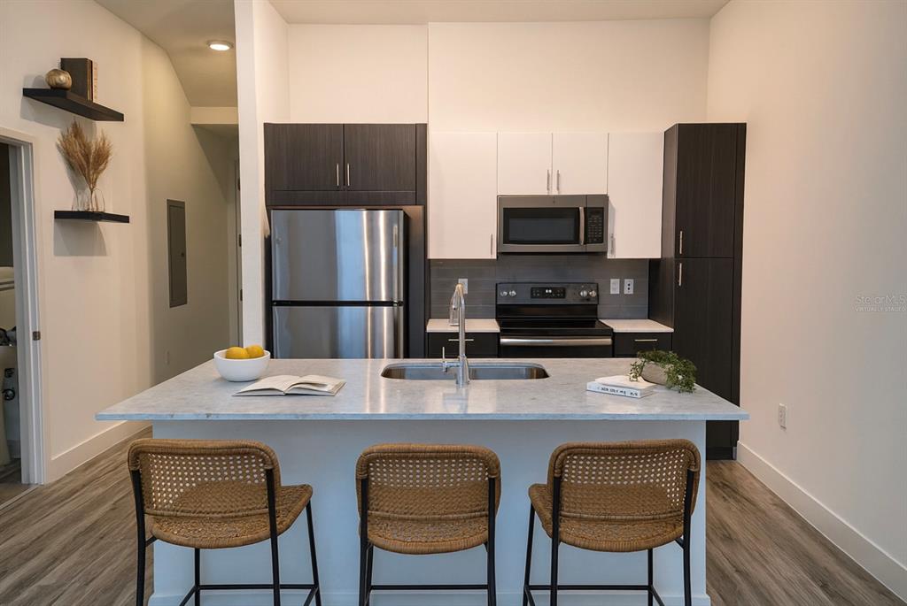 1659 2nd Street Sarasota, FL 34236 - Photo 2 of 24 a kitchen with stainless steel appliances a stove refrigerator and microwave