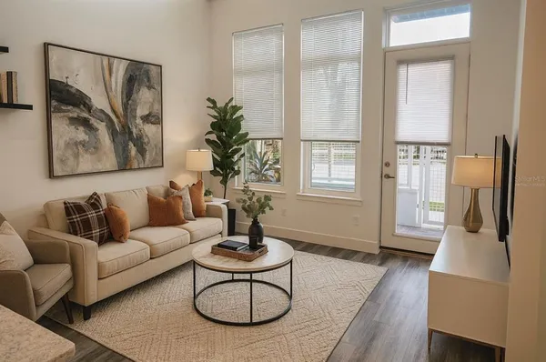 a living room with furniture fireplace and wooden floor