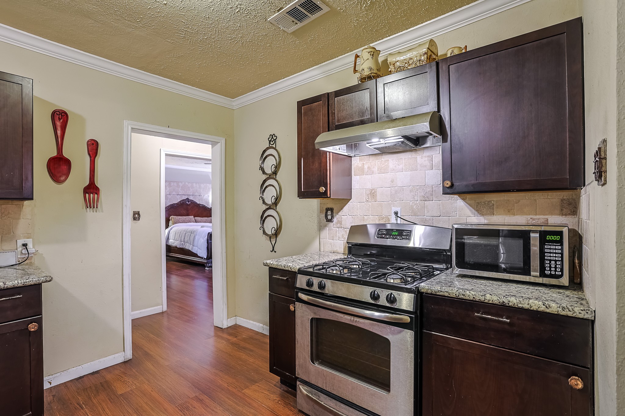 776 Fair Street Houston, TX 77088 - Photo 7 of 14 a kitchen with stainless steel appliances granite countertop a stove and a wooden cabinets