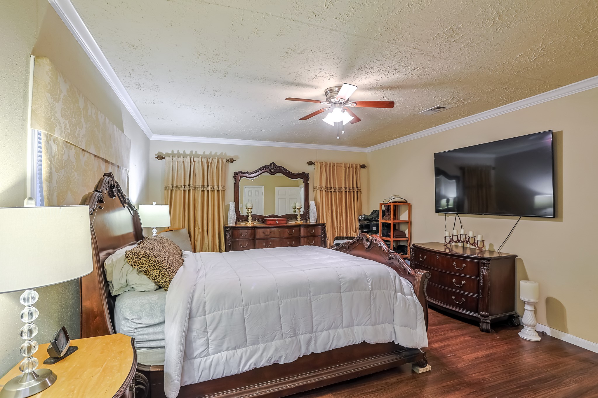 776 Fair Street Houston, TX 77088 - Photo 10 of 14 a bedroom with a bed a flat screen tv and a couch