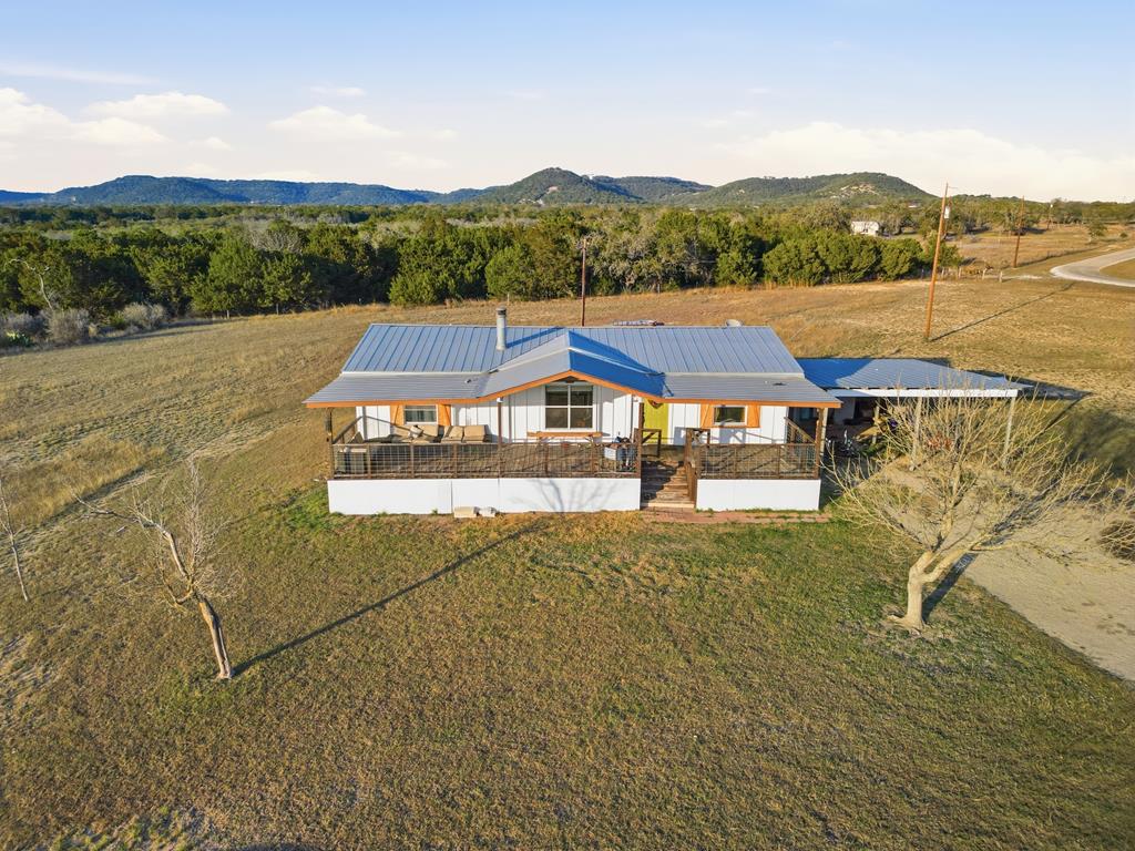 127 Windmill Drive Bandera, TX 78003 - Photo 1 of 29 a view of a lake with a mountain in the background