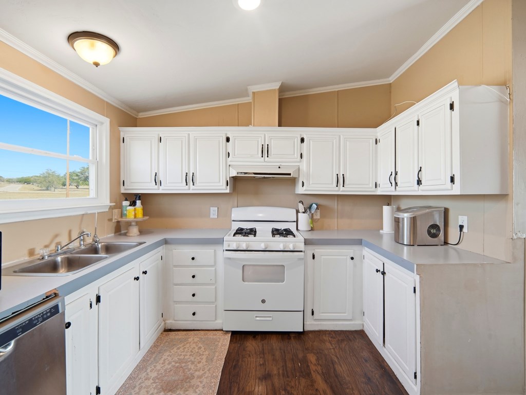 127 Windmill Drive Bandera, TX 78003 - Photo 13 of 29 a kitchen with cabinets and wooden floor