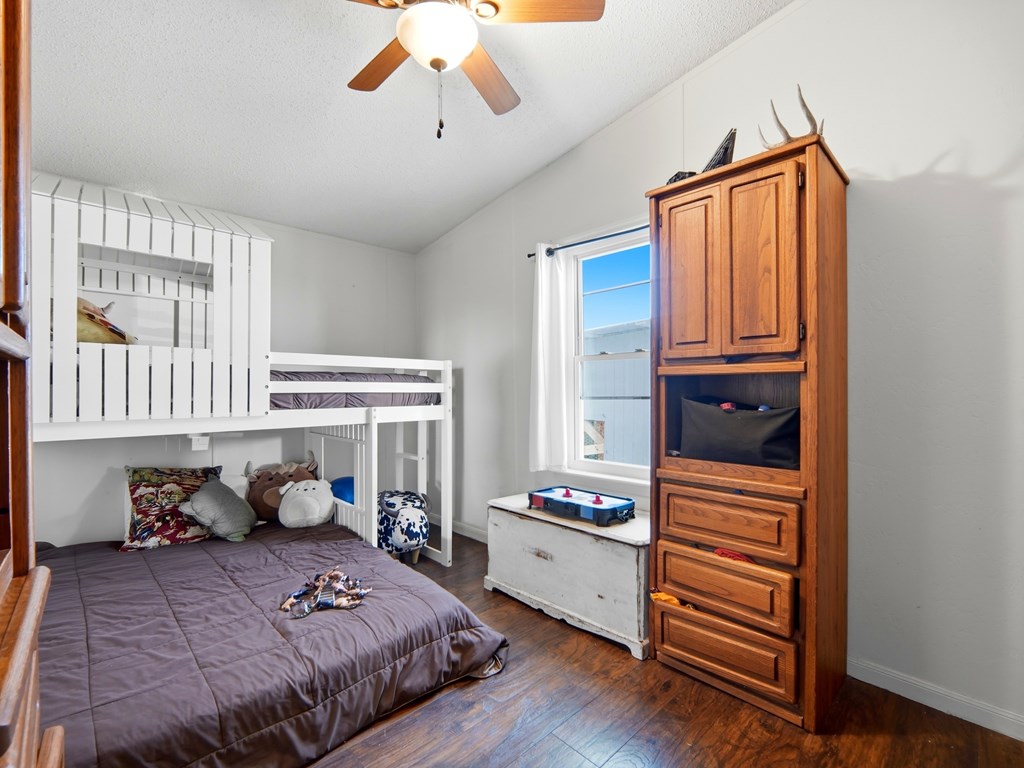 127 Windmill Drive Bandera, TX 78003 - Photo 18 of 29 a bedroom with furniture and a window