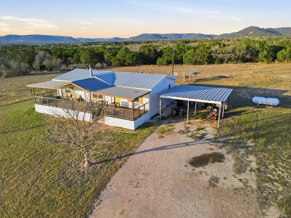 127 Windmill Drive Bandera, TX 78003 - Photo 2 of 29 a view of a house with pool and a yard