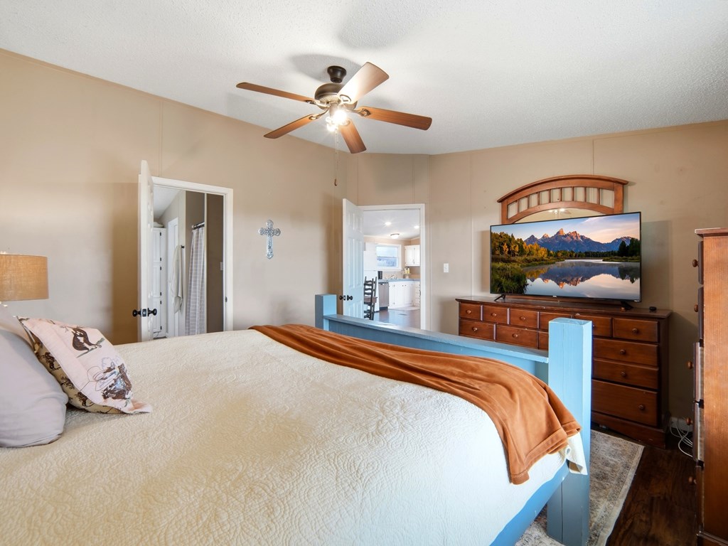 127 Windmill Drive Bandera, TX 78003 - Photo 21 of 29 a bedroom with a bed and a mirror on dresser