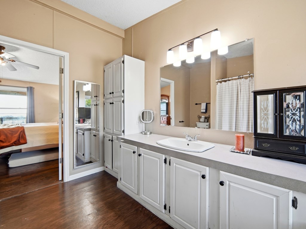 127 Windmill Drive Bandera, TX 78003 - Photo 22 of 29 a bathroom with double vanity sinks a mirror and a shower