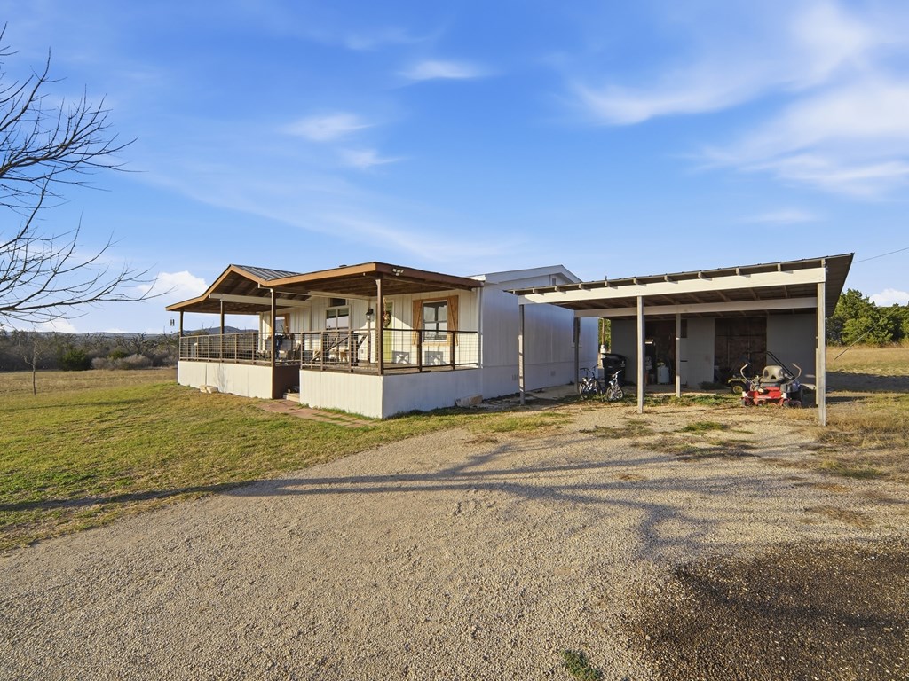 127 Windmill Drive Bandera, TX 78003 - Photo 4 of 29 a front view of a house with a garden