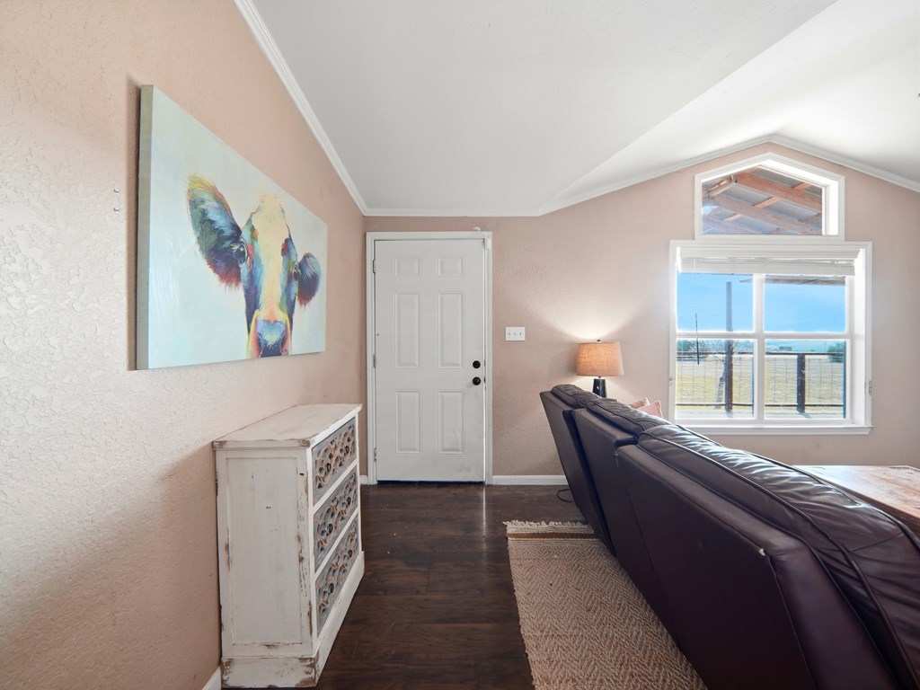 127 Windmill Drive Bandera, TX 78003 - Photo 6 of 29 a bedroom with a bed and a painting on the wall