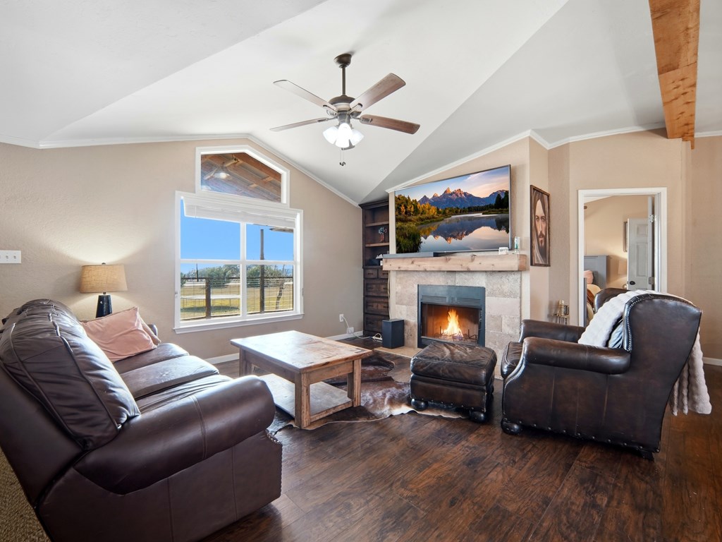 127 Windmill Drive Bandera, TX 78003 - Photo 7 of 29 a living room with furniture a fireplace and a flat screen tv