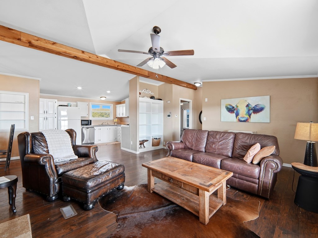 127 Windmill Drive Bandera, TX 78003 - Photo 9 of 29 a living room with furniture a ceiling fan and a rug