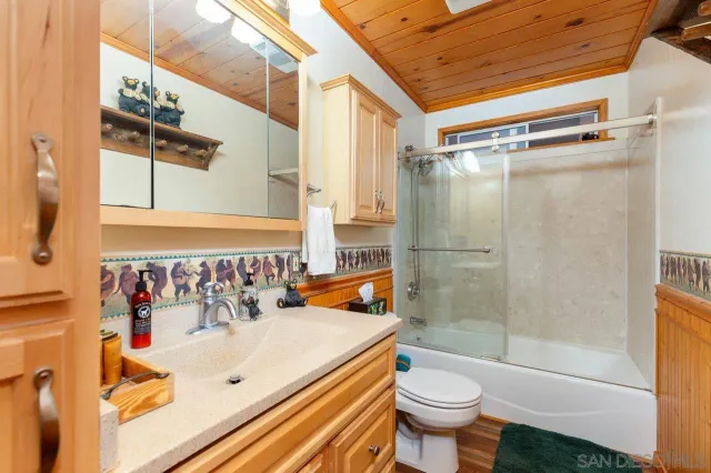 a bedroom with a bed and a large window with outer view