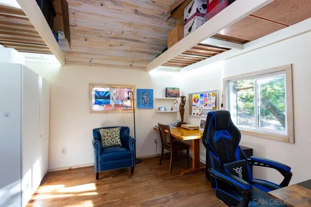 a workspace with furniture hardwood and a window