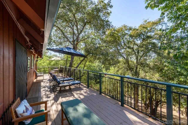 a view of a patio with table and chairs under an umbrella
