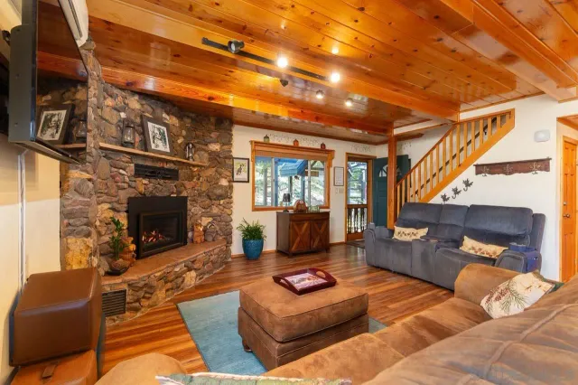 a living room with furniture a fireplace and a flat screen tv