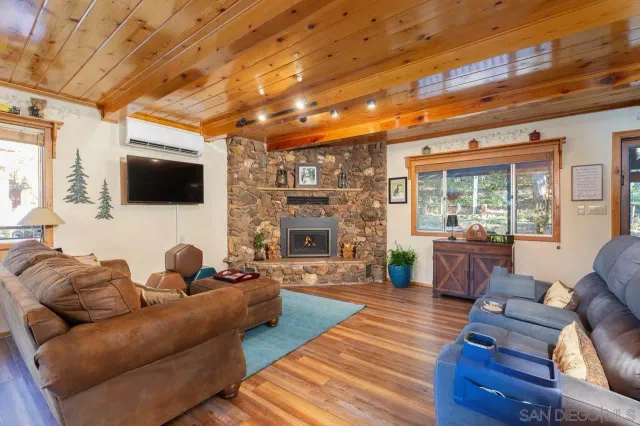 a living room with furniture a fireplace and a flat screen tv